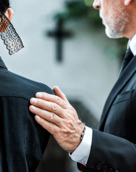 cropped-view-of-man-touching-woman-on-funeral-WXHCDM2_Easy-Resize.com